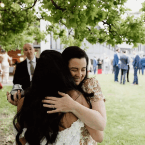Celebrant hugging bride after wedding