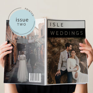 Women reading issue 2 of Isle Weddings magazine