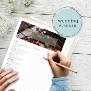 Women writing on her free downloaded wedding planner Isle Weddings